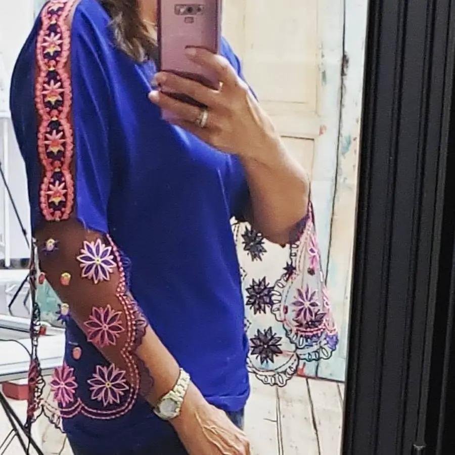 Touch of Lace with Angela Wolf blue top featuring pink embroidered sheer sleeves; floral tote visible