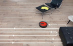 Miele Scout RX1 red robot vacuum on hardwood floor