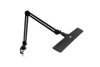 Lumi Task Lamp Satin Black by Daylight with adjustable arms and clamp base, plus desk mat.