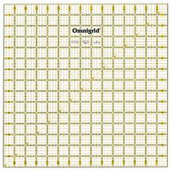 Omnigrid 15x15 inch ruler for textile art with gold grid markings on pale background