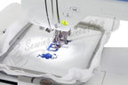 Refurbished Brother PE-770 embroidery machine stitching a blue floral design in a hoop.