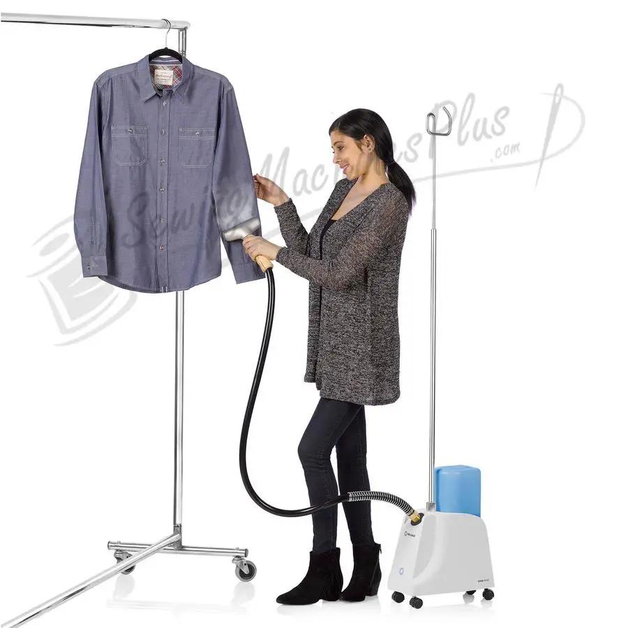Reliable Vivio 150GC garment steamer; white unit with blue water tank steaming a blue shirt on a rolling clothing rack