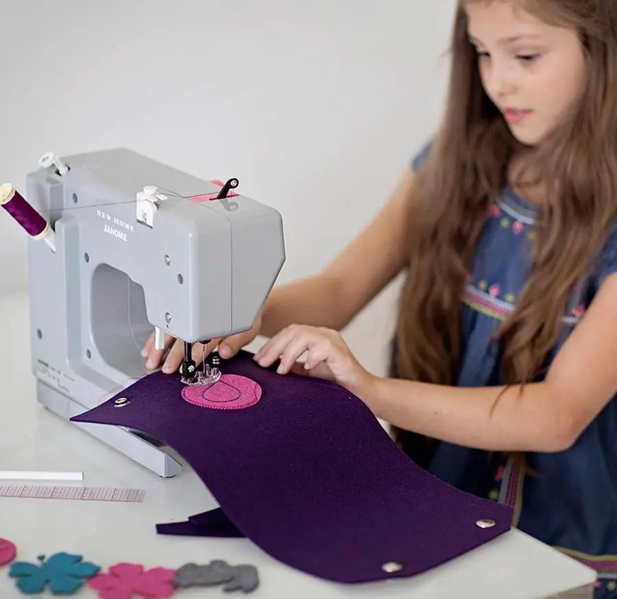 Bluefig University Learn to Sew Kit Lil Sleeve Class 200 fabric kit, girl sewing purple fabric on a sewing machine