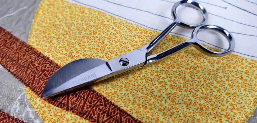 Floriani Applique Plus Scissors, stainless steel applique scissors with chrome blades, on quilt fabric