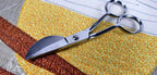 Floriani Applique Plus Scissors, stainless steel applique scissors with chrome blades, on quilt fabric
