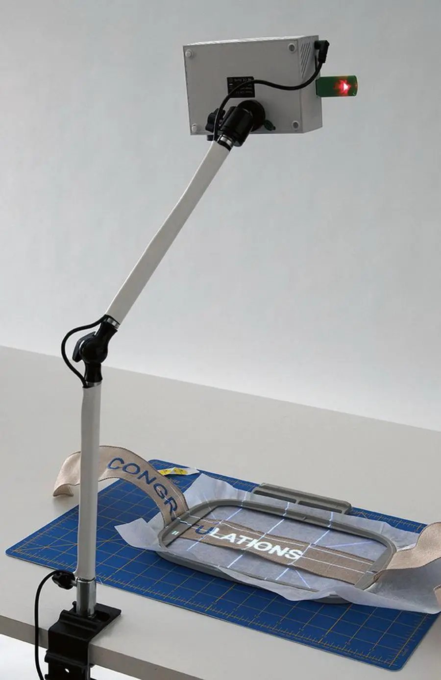 DIME Maximum View Projector on an adjustable white arm desk stand
