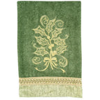 Anita Goodesign Christmas Curls 115MAGHD embroidery design on green towel with gold holly motif and lace border.