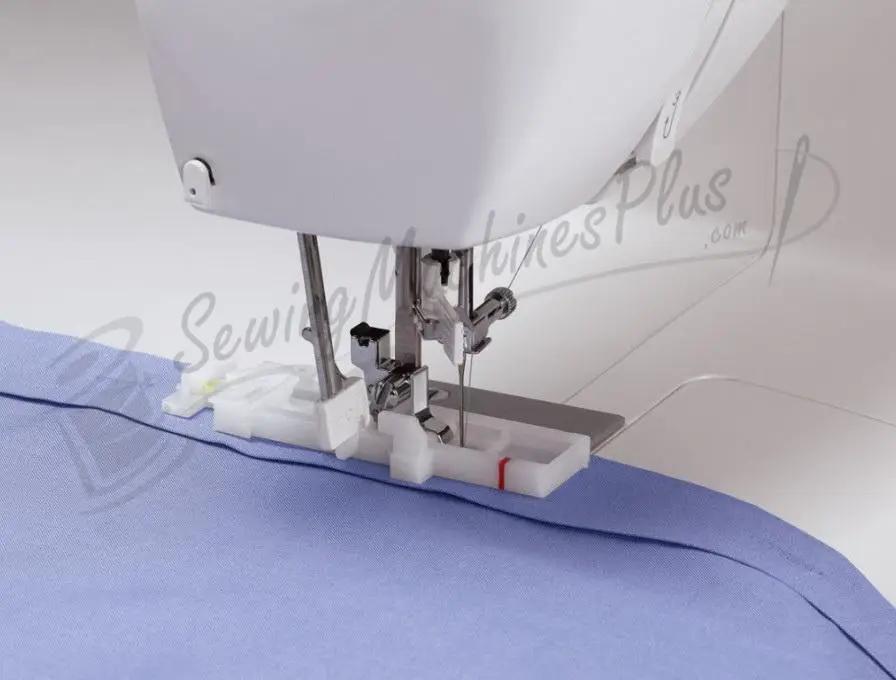 Singer 6199 Brilliance sewing machine stitching blue fabric; white electronic model.