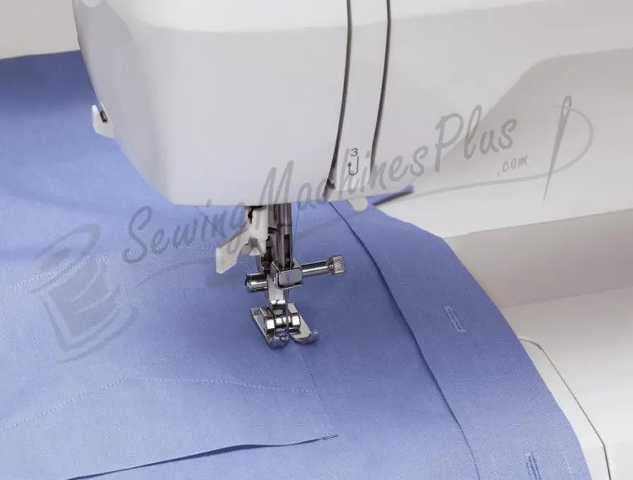 Singer 6199 Brilliance sewing machine with presser foot on blue fabric