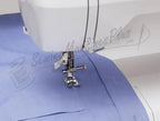 Singer 6199 Brilliance sewing machine with presser foot on blue fabric