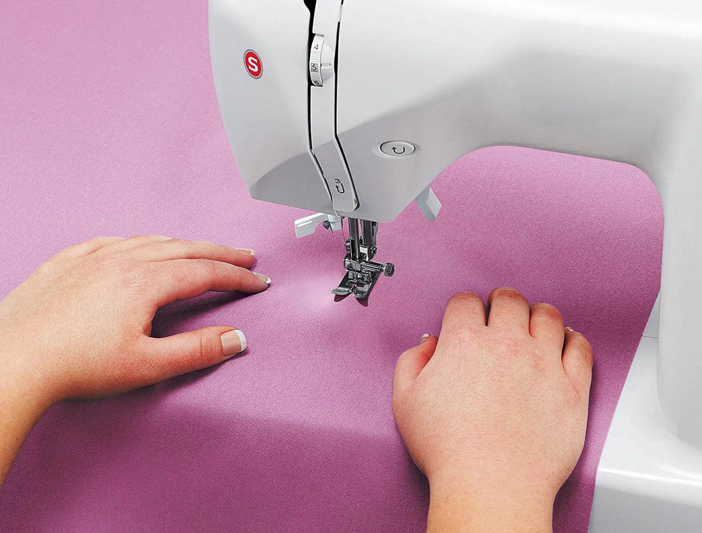 Singer Starlet sewing machine in gray with pink fabric under the presser foot