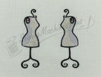 Embroidery design of two beige dress forms on white fabric