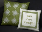 Set of 2 pillows: green with white snowflake embroidery; white with green border and Live Love Laugh embroidery.