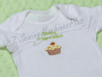 White baby T-shirt with small cupcake embroidery on the front; faint watermark across.