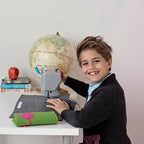 Bluefig University Learn to Sew Kit Lil Ruck Class 300 fabric kit; child sews gray fabric at a sewing machine.