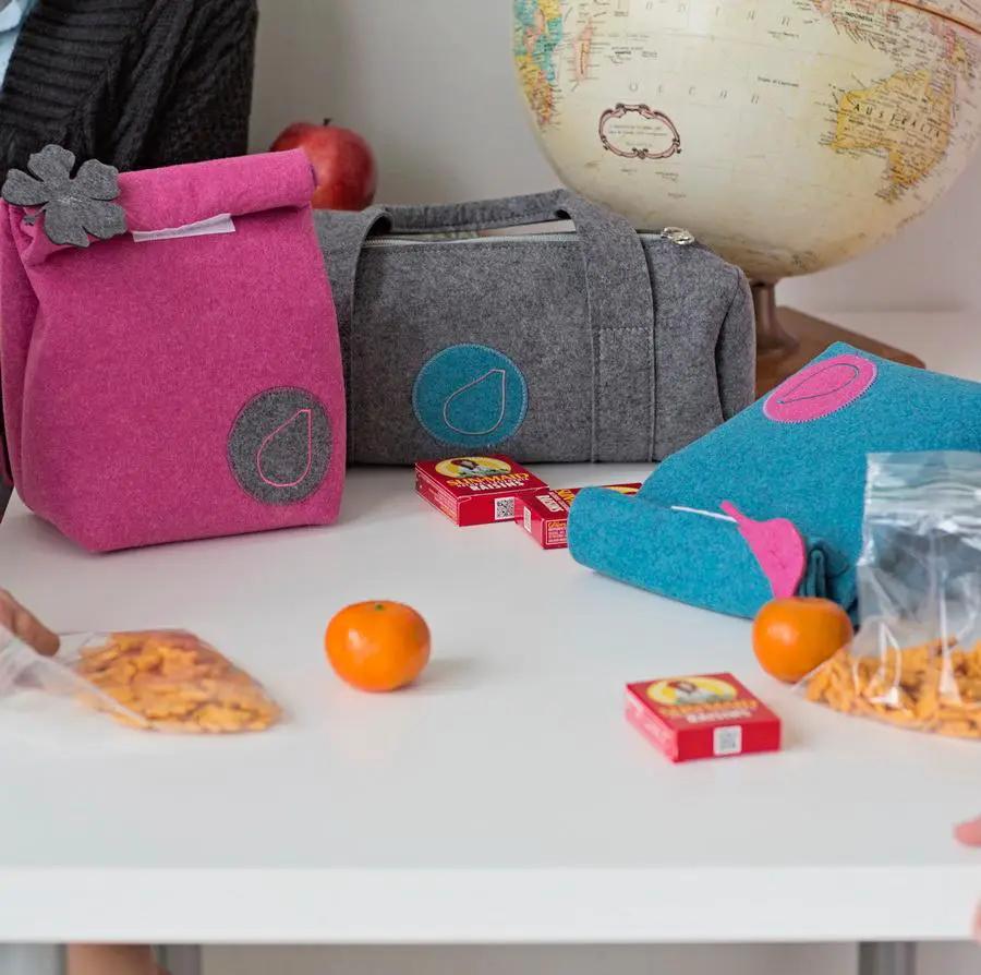 Bluefig University Learn to Sew Kit Lil Snacker Class 100 peacock blue fabric kit with pink and gray pouches on a table