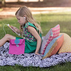 Bluefig University Learn to Sew Kit Lil Sleeve Class 200 fabric kit, child sits outdoors with pink bag and earphones.