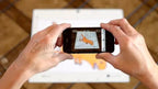 Cameo PixScan Cutting Mat by Silhouette, CUT-MAT-PIX8-3T, held while a smartphone photographs it