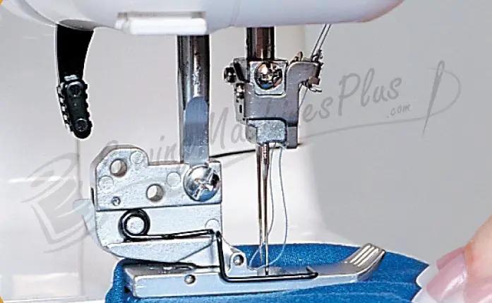 Janome 1000CPX Cover Pro coverstitch machine, refurbished; close-up of needle and presser foot.