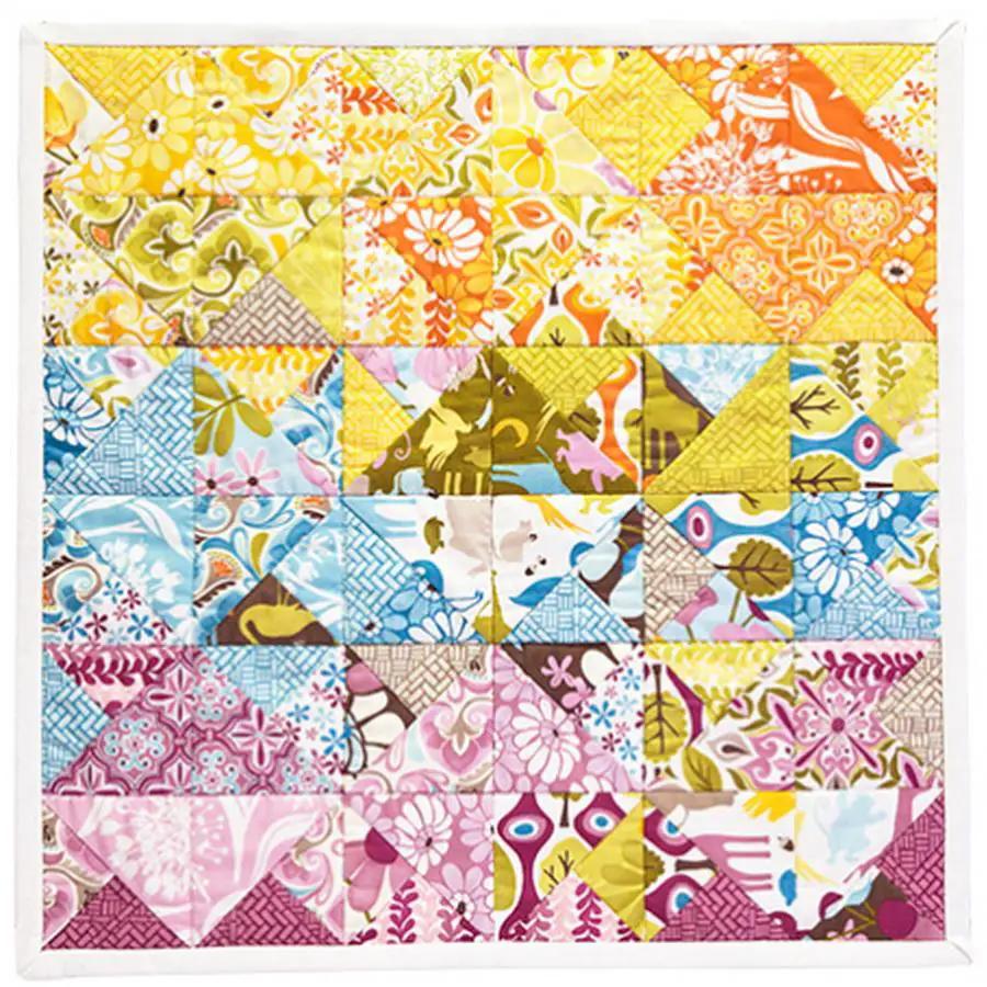 Anita Goodesign Charm Pack Quilt Blocks, colorful floral fabric triangles in a patchwork layout