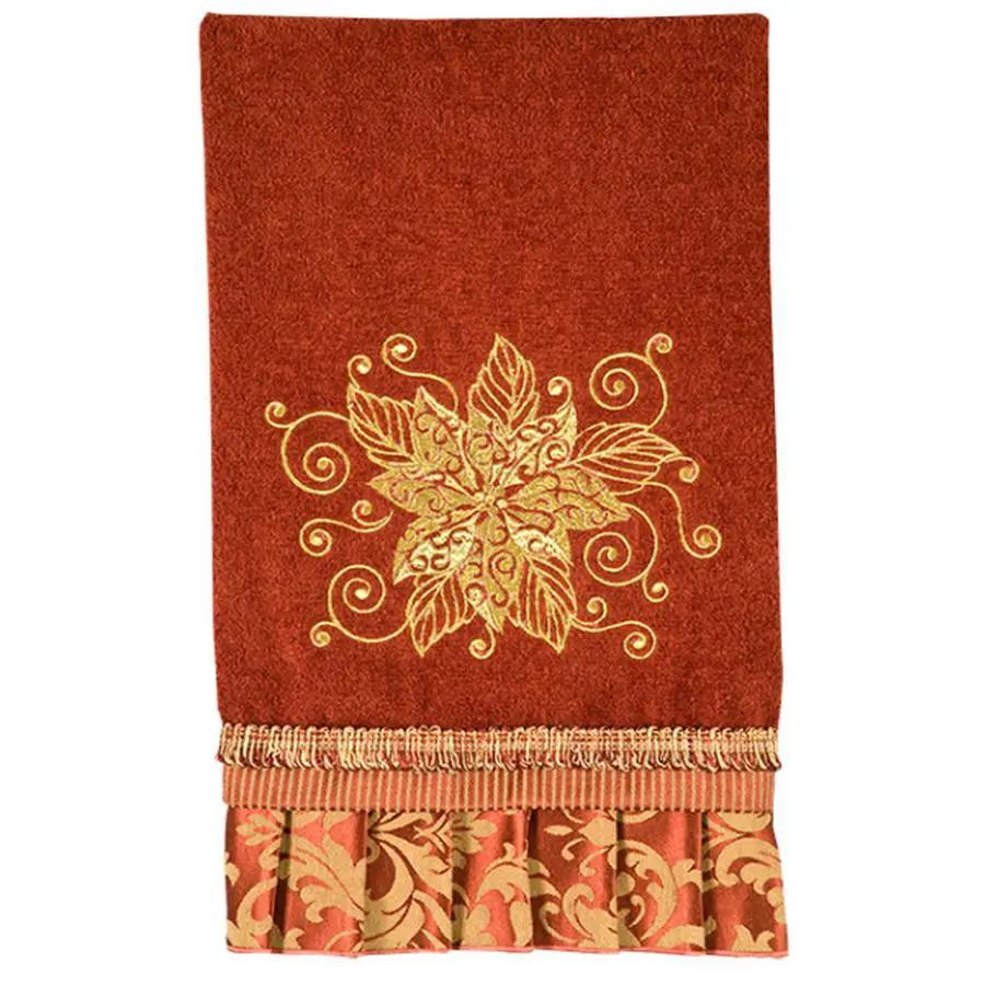 Anita Goodesign Christmas Curls 115MAGHD embroidery design on red towel with gold floral motif and fringed edge.