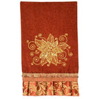 Anita Goodesign Christmas Curls 115MAGHD embroidery design on red towel with gold floral motif and fringed edge.