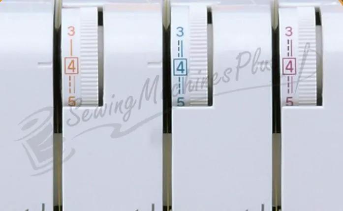 Janome 1000CPX Cover Pro coverstitch machine close-up of three color-coded dials.