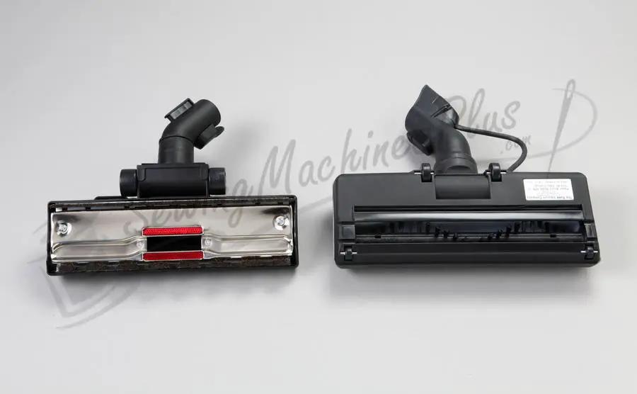 Two The Bank Vault canister vacuum heads, black with chrome front plate and red brush.