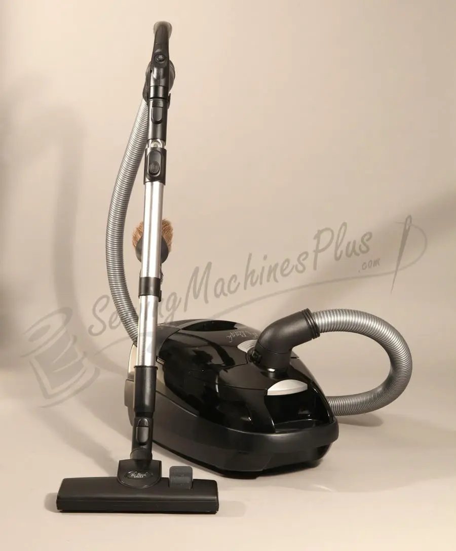 The Bank Vault Canister Vacuum, black canister with metal wand, flexible hose, and floor brush.