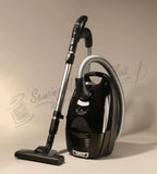 The Bank Vault canister vacuum with black glossy body and metal wand