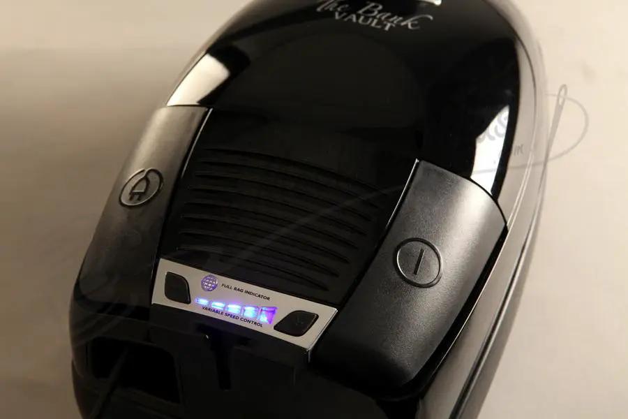 The Bank Vault canister vacuum in black with a silver control panel.