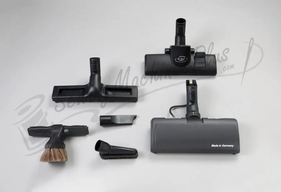 The Bank Vault Canister Vacuum with multiple black attachments and floor heads, Made in Germany